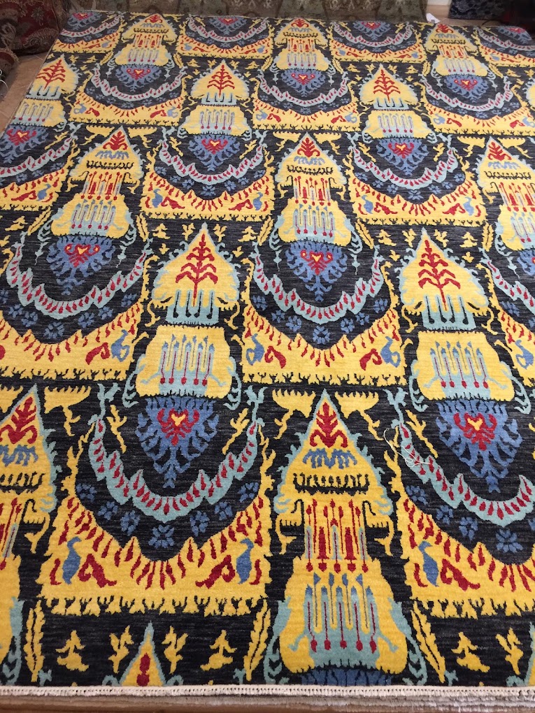 Bold multicolor handmade rug pattern in gold, navy, red, and blue