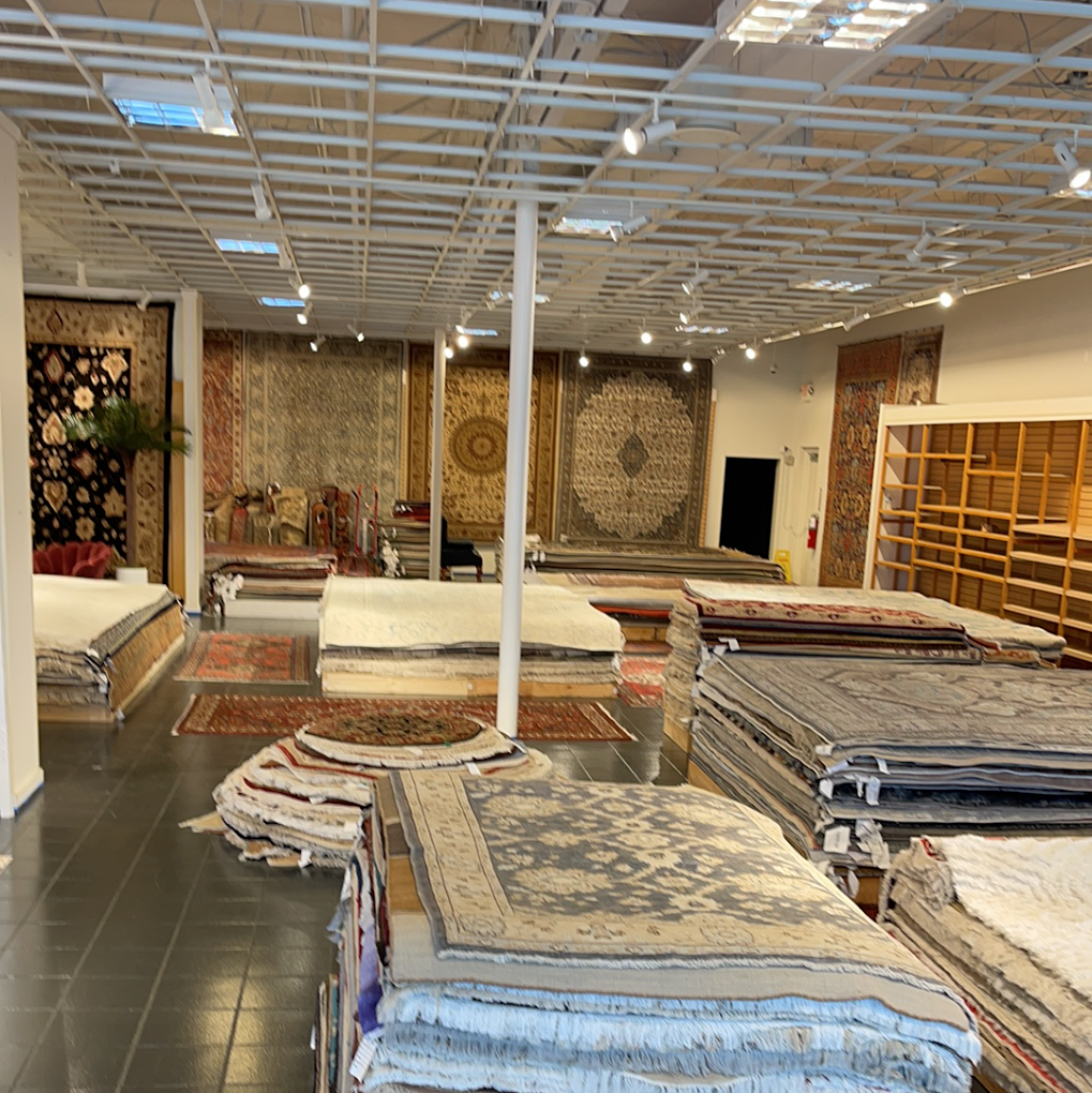 Stacks of handmade, Oriental, and area rugs in the Orlando showroom