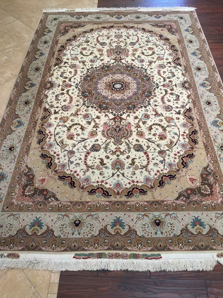 Traditional Oriental rug with a detailed central medallion and floral border