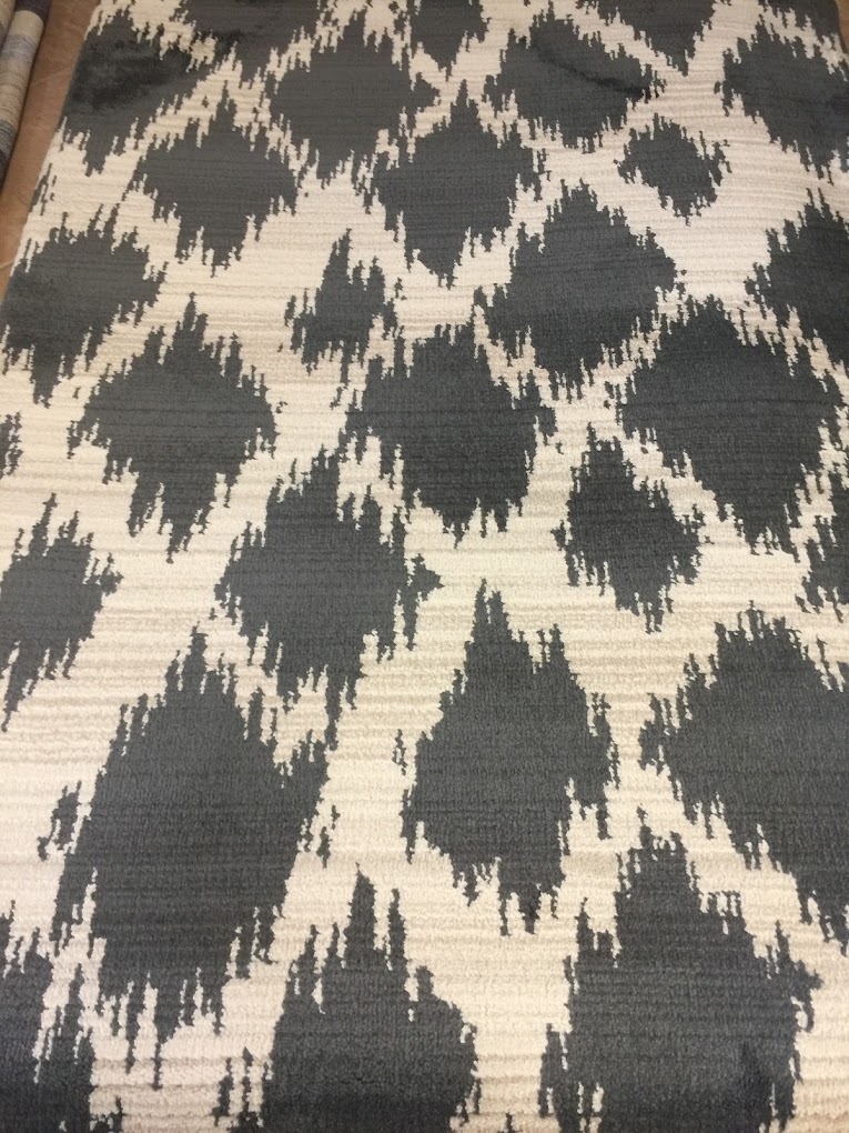 Charcoal and ivory geometric rug with a bold repeating pattern